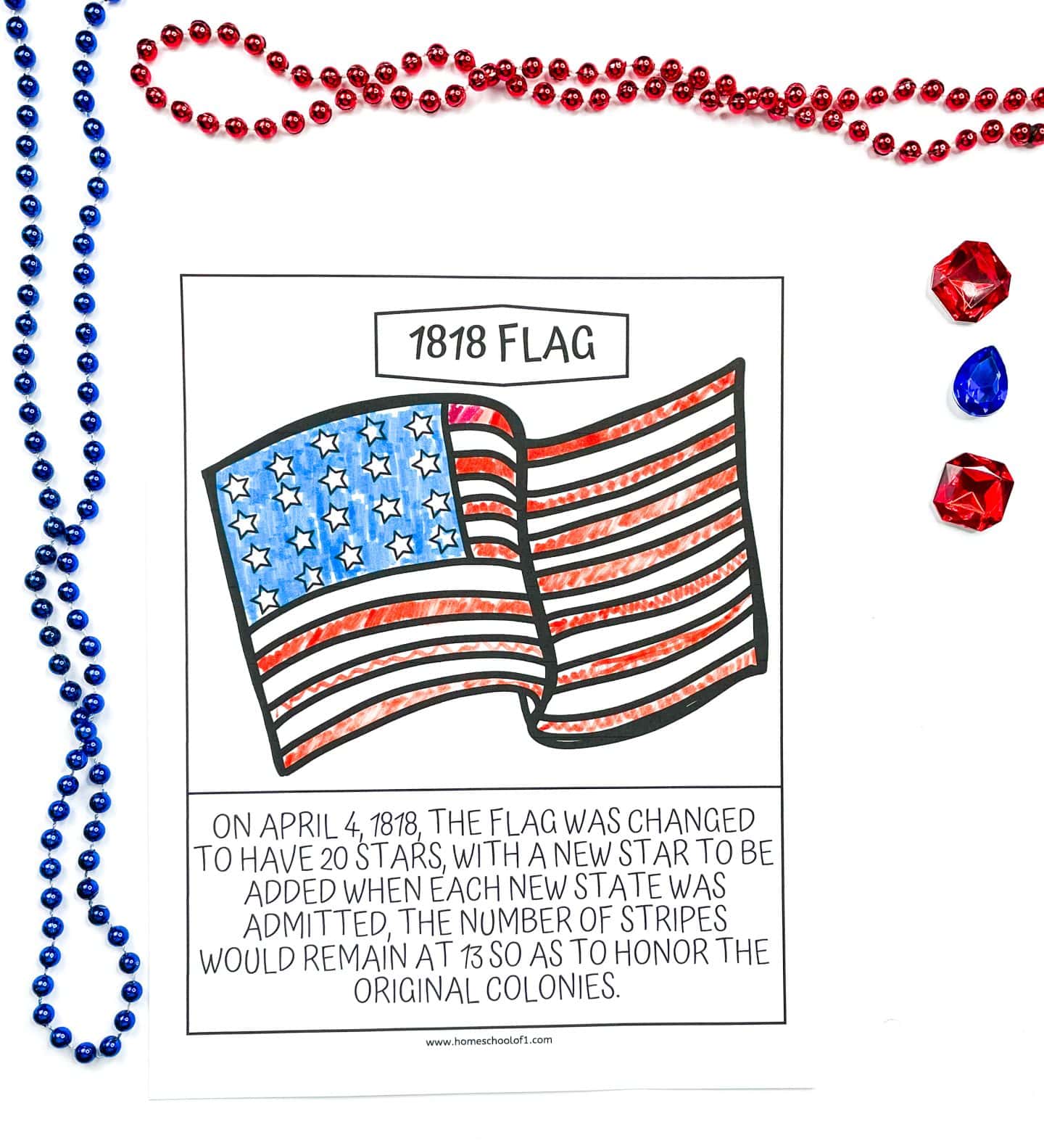 A coloring page titled “1818 Flag” showing a hand-colored version of the United States flag with 20 white stars on a blue field and 13 red and white stripes. The caption explains that on April 4, 1818, the flag was changed to include 20 stars with one added for each new state, while the stripes would remain at 13 to honor the original colonies. The page is surrounded by red and blue bead necklaces and three plastic gem decorations.