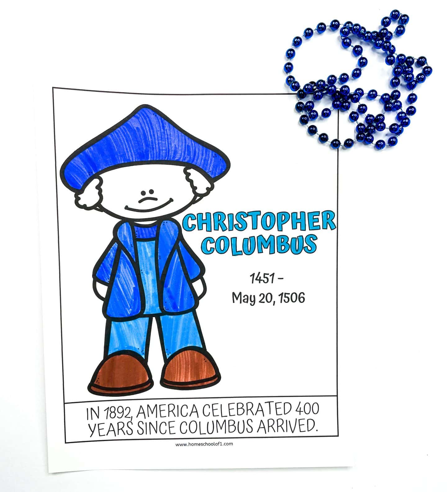 Coloring worksheet featuring a cartoon version of Christopher Columbus in a blue outfit and brown shoes. The page includes his name, birth year (1451), and death date (May 20, 1506), along with the caption “In 1892, America celebrated 400 years since Columbus arrived.” A string of blue beads is placed beside the page on a white background.