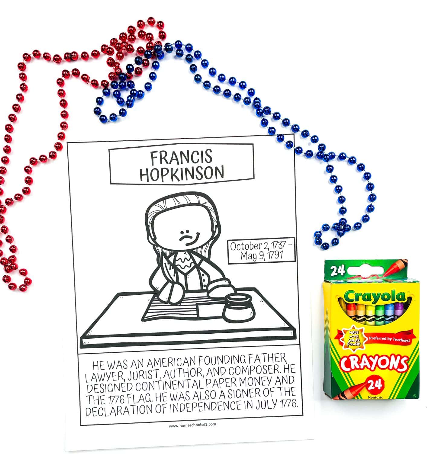 A black and white coloring page featuring a cartoon drawing of Francis Hopkinson seated at a desk with a quill and ink, accompanied by his birth and death dates (October 2, 1737 – May 9, 1791). Below, text explains he was a founding father, lawyer, jurist, author, and composer, credited with designing the 1776 American flag and signing the Declaration of Independence. Red and blue beaded necklaces are draped around the page, and a 24-pack of Crayola crayons is placed beside it.