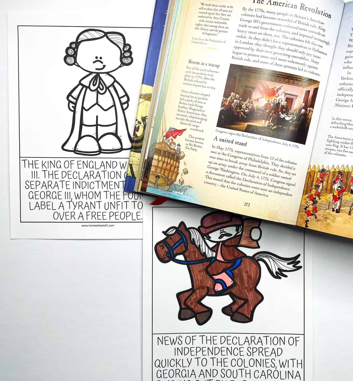 two worksheets on the Declaration of Independence. One shows a cartoon figure of King George III with text explaining his role in the Declaration's accusations. The other worksheet displays a cartoon of a messenger riding a horse with the text about the Declaration of Independence spreading quickly to the colonies, particularly Georgia and South Carolina. A history book about the American Revolution is placed above the worksheets.