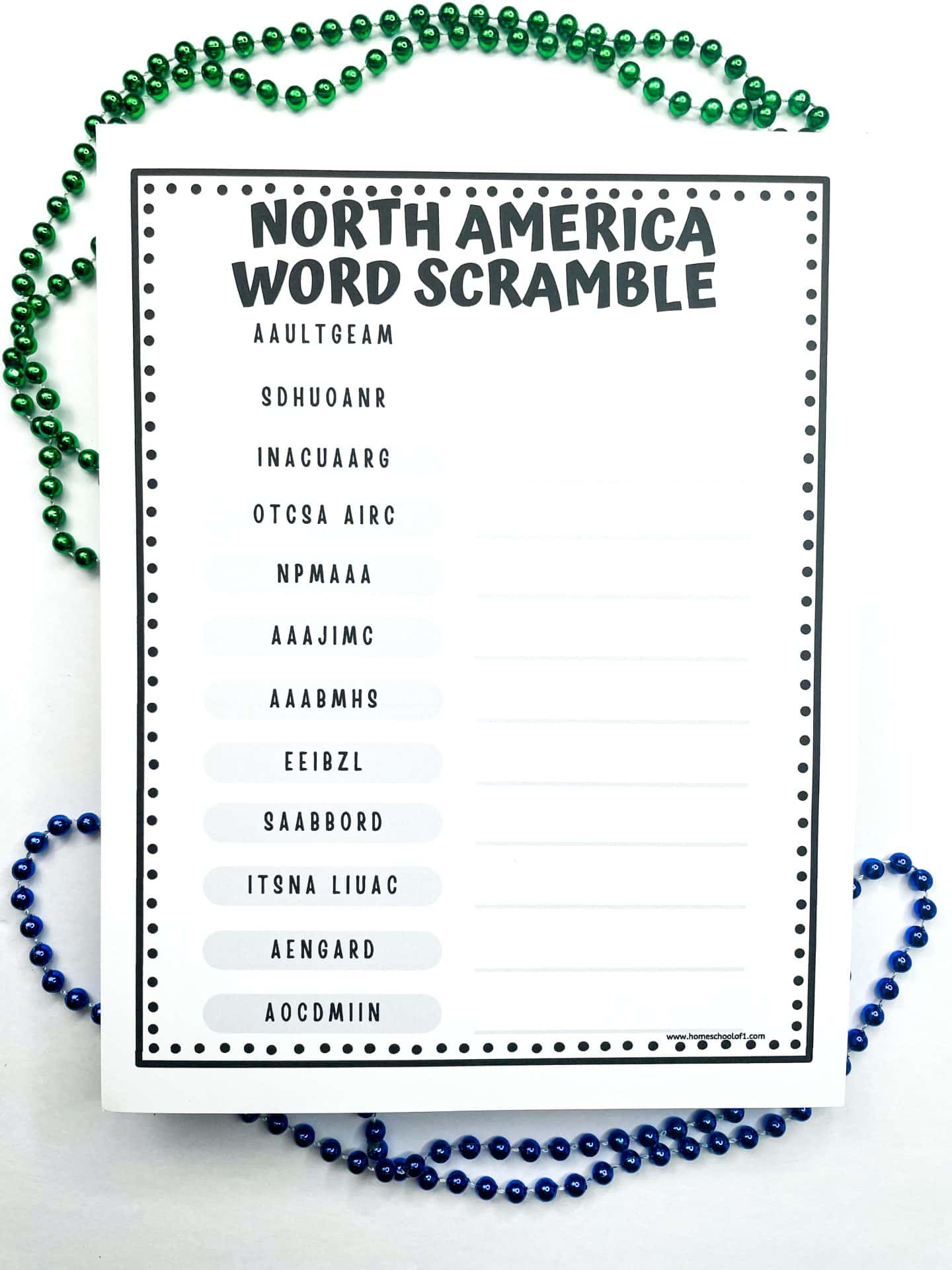 A printable black and white worksheet titled “North America Word Scramble” featuring a list of scrambled country names such as AAULTGEAM, SDHUOANR, and INACUAARG for students to unscramble. Decorative green and blue bead necklaces are arranged around the worksheet.