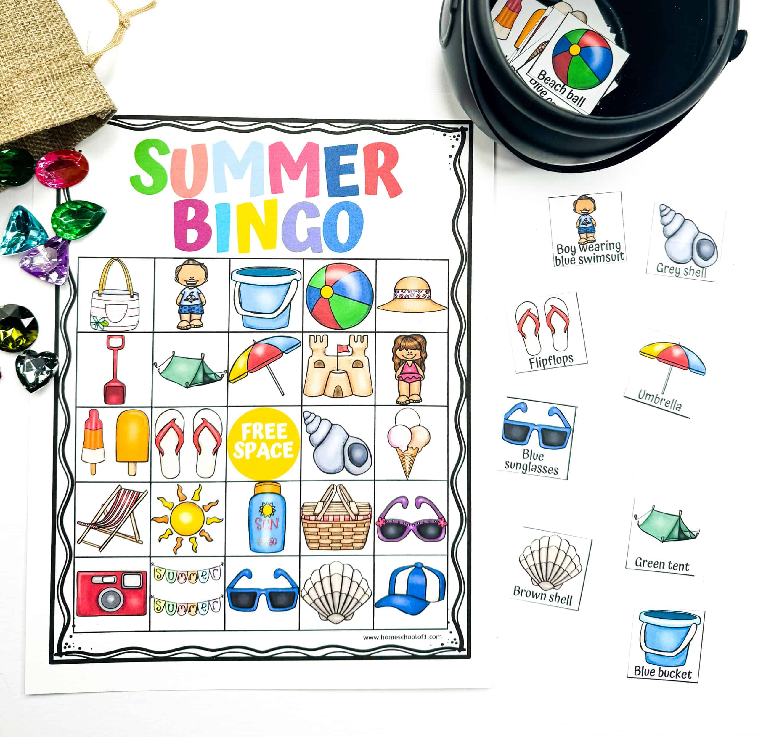 Bright and playful summer bingo printable featuring a full bingo card with colorful beach icons like a beach ball, ice cream, sunscreen, and sandcastle, alongside matching calling cards labeled with words like “umbrella” and “blue sunglasses.” Ideal for a kids summer game that’s both educational and entertaining, with gem tokens for added fun.