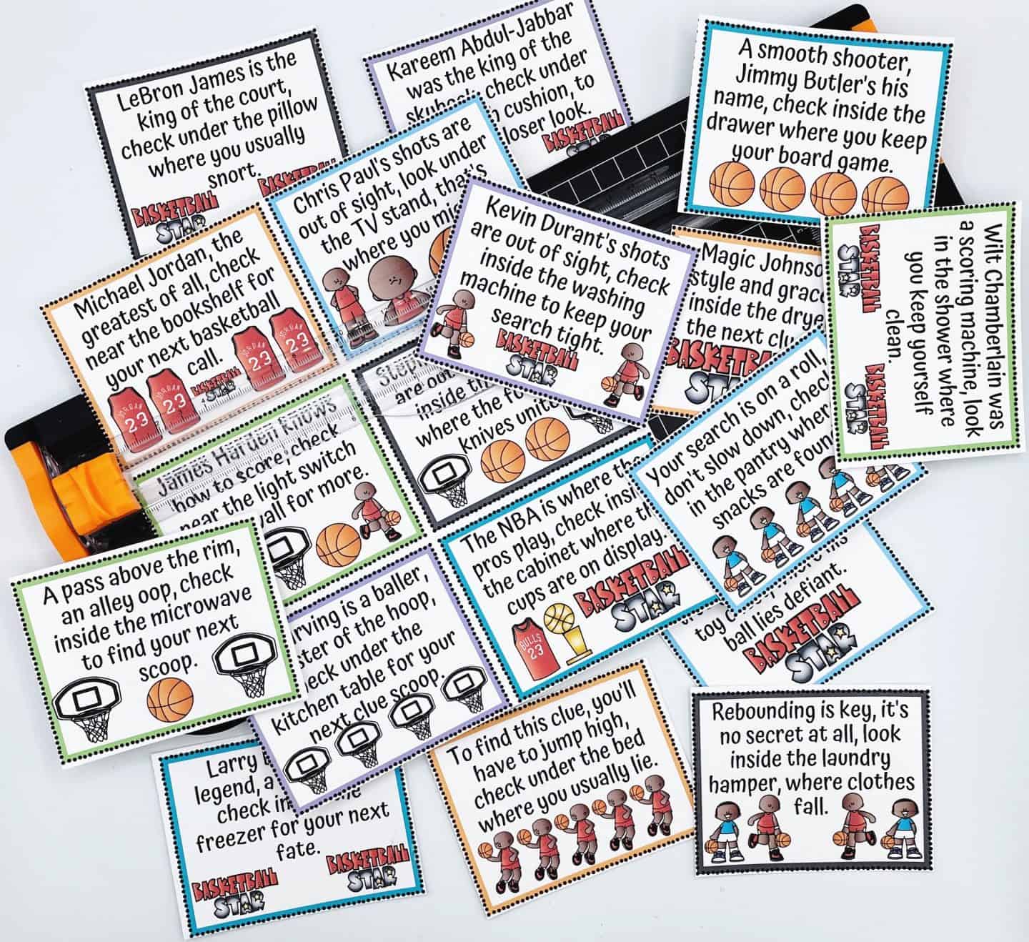 A colorful assortment of basketball-themed scavenger hunt clue cards scattered across a white surface. Each card features a rhyme referencing iconic players like LeBron James, Michael Jordan, and Kevin Durant, leading kids to search household spots such as under pillows, inside the microwave, and near the washing machine. Illustrations of basketballs and cartoon players decorate the cards, adding a playful touch.