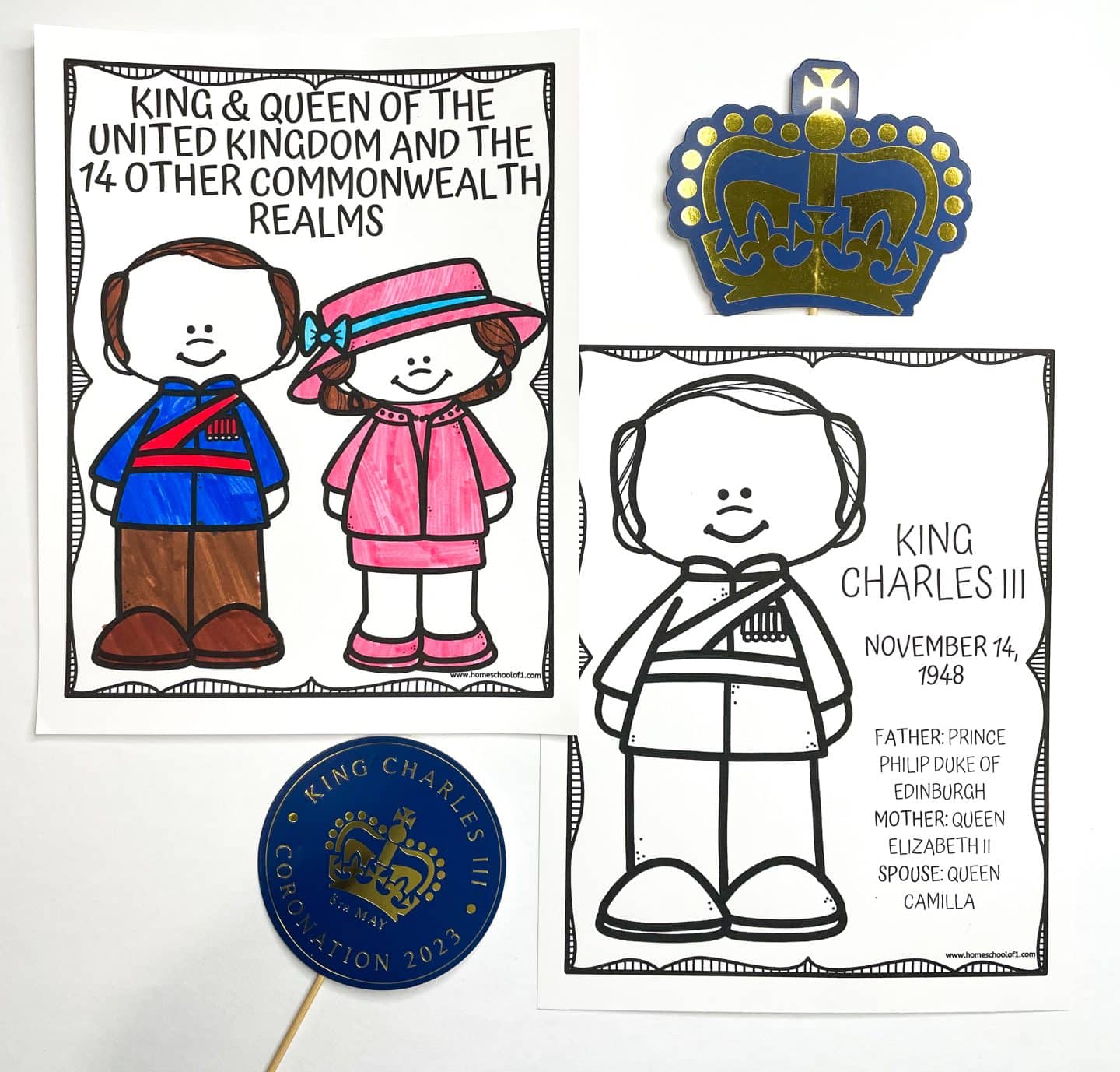 Two British royal family-themed coloring pages are shown. One is colored, featuring cartoon figures of the King and Queen of the United Kingdom dressed in blue, brown, and pink, labeled "King & Queen of the United Kingdom and the 14 Other Commonwealth Realms." The other is an uncolored page of King Charles III, including his birthdate (November 14, 1948) and family info. Decorative items like a paper crown and a round sign reading "King Charles III Coronation 2023" are also visible.