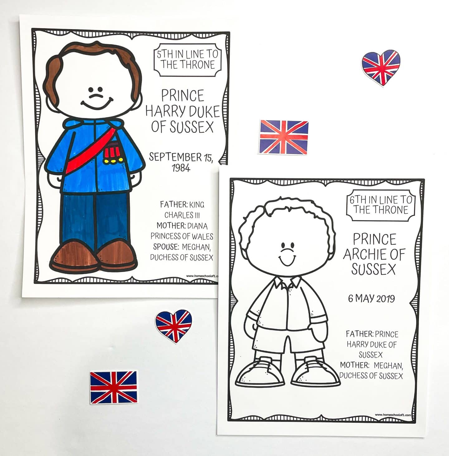 Two royal-themed coloring pages feature cartoon characters of Prince Harry, Duke of Sussex, and his son, Prince Archie of Sussex. Prince Harry’s page is colored in with blue, red, and brown and notes his birthdate (September 15, 1984), parents, and spouse. Archie’s uncolored page states he is “6th in Line to the Throne,” born May 6, 2019, with his parents listed as Prince Harry and Meghan, Duchess of Sussex. Three Union Jack decorations, including a heart-shaped sticker, are placed around the pages.