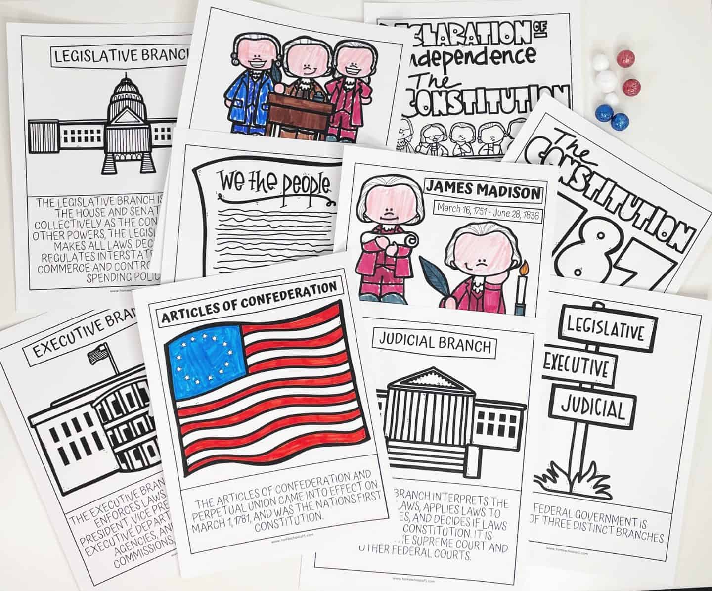 A collection of U.S. history worksheets featuring topics related to the Constitution and government. The pages include illustrations and explanations of the Legislative Branch, Judicial Branch, Executive Branch, the Articles of Confederation, James Madison, the Declaration of Independence, and the Constitution of 1787. There are also references to "We the People" and the structure of U.S. government branches. Red, white, and blue candies are scattered in the background.