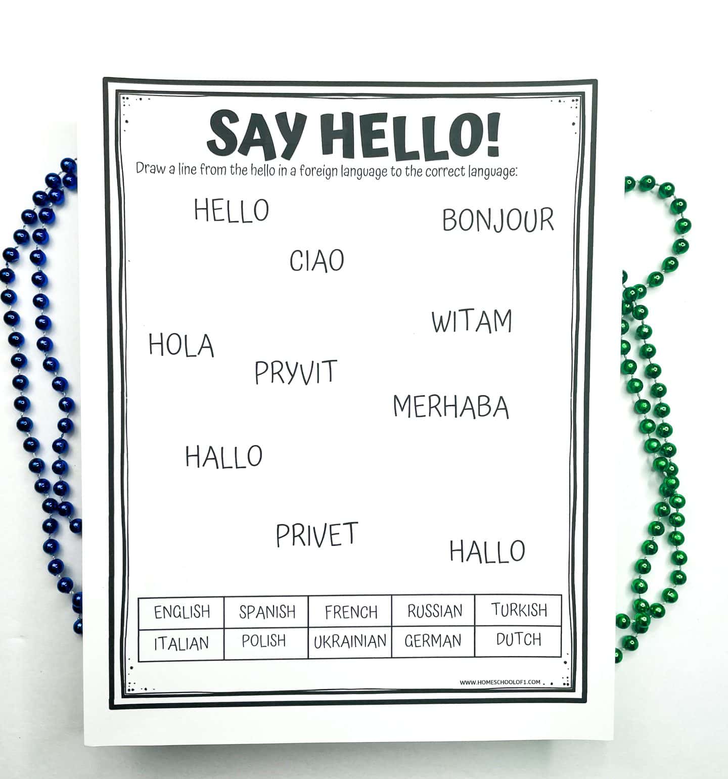 Printable “Say Hello!” worksheet that prompts students to match the word “hello” in various languages (like Ciao, Bonjour, Hola, Merhaba, Pryvit) with the correct language from a word bank at the bottom, including English, Spanish, French, Russian, Turkish, and more. Blue and green bead strands decorate the white background.