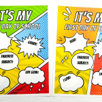 A pair of 'First Day of Homeschool' signs with vibrant comic book-inspired graphics in yellow, blue, and red, with speech bubbles for personalizing 'YEAR,' 'GRADE,' 'FAVORITE SUBJECT,' and 'LIFE GOAL.' The background displays a beaded necklace framing the page.