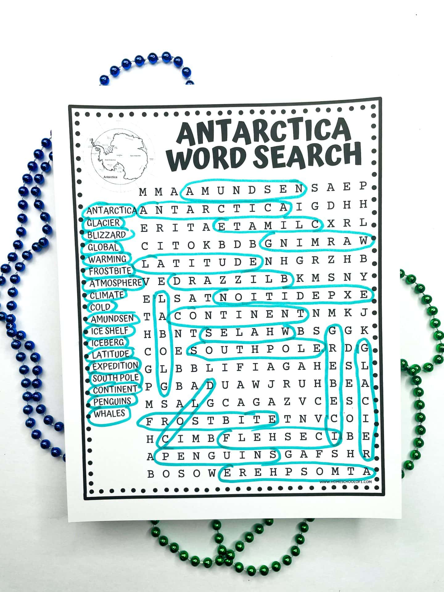 Printable “Antarctica Word Search” worksheet for kids with themed vocabulary like “glacier,” “blizzard,” and “penguins” circled in blue, surrounded by green and blue beads on a white background.