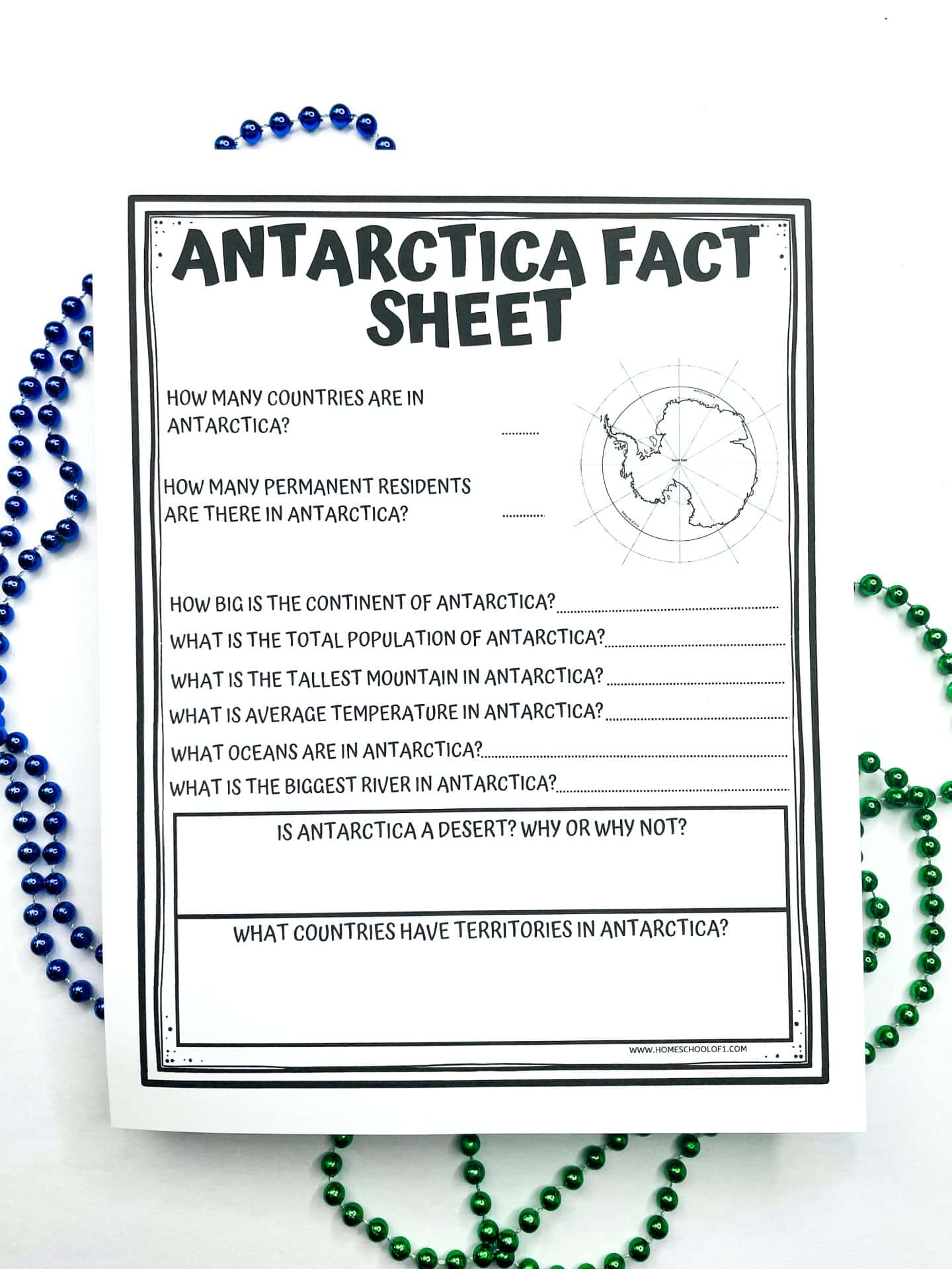 Black-and-white printable “Antarctica Fact Sheet” worksheet for kids with questions about Antarctica’s population, geography, climate, and political territories, shown with green and blue beaded necklaces around it.