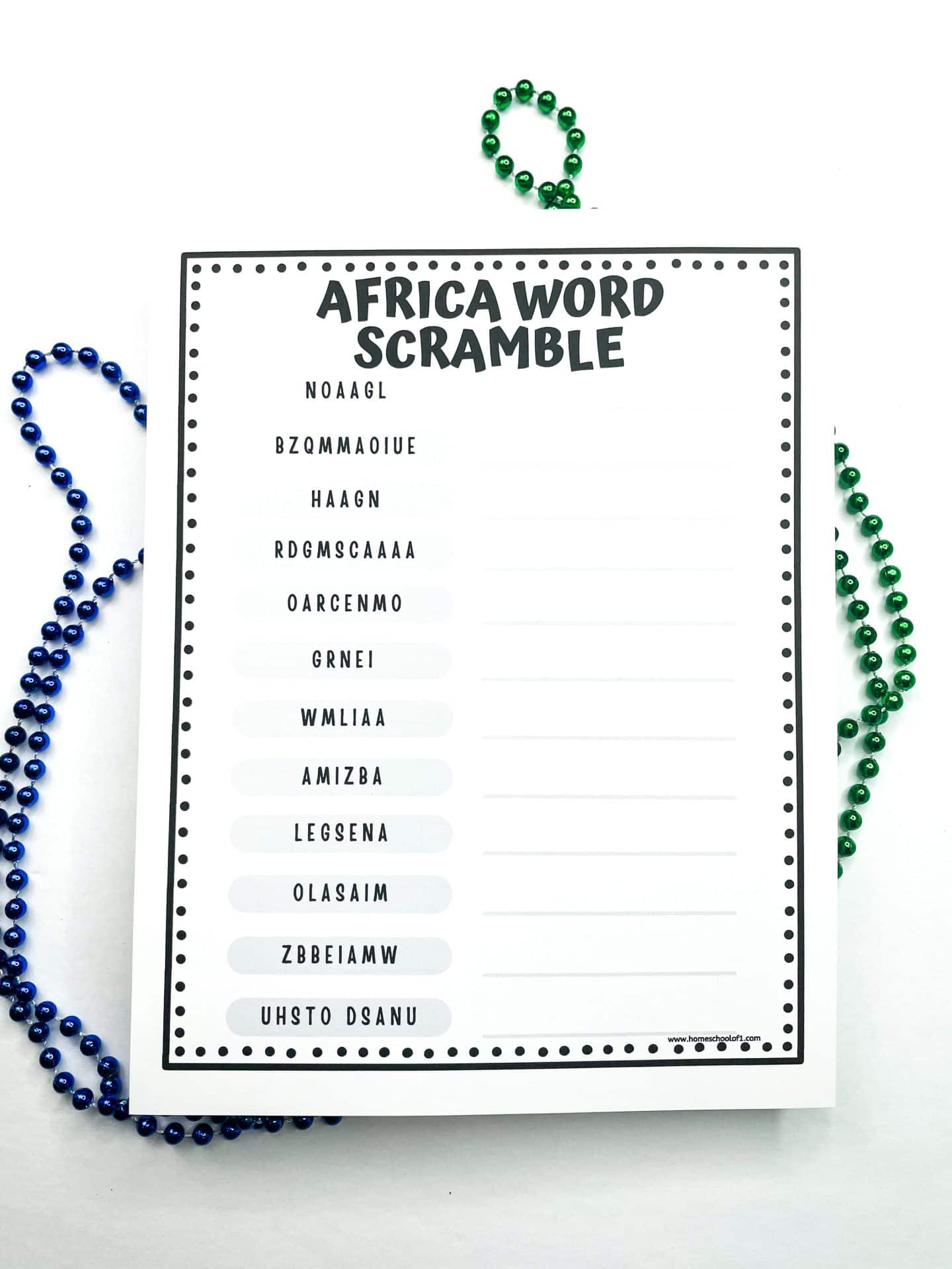 Printable "Africa Word Scramble" worksheet featuring a list of scrambled country names in black text, such as "NOAAGL" and "BZQMAOIUE," with blank spaces next to each for writing the correct answer. The page is decorated with a dotted border, and green and blue beaded necklaces are arranged around the worksheet on a white background.
