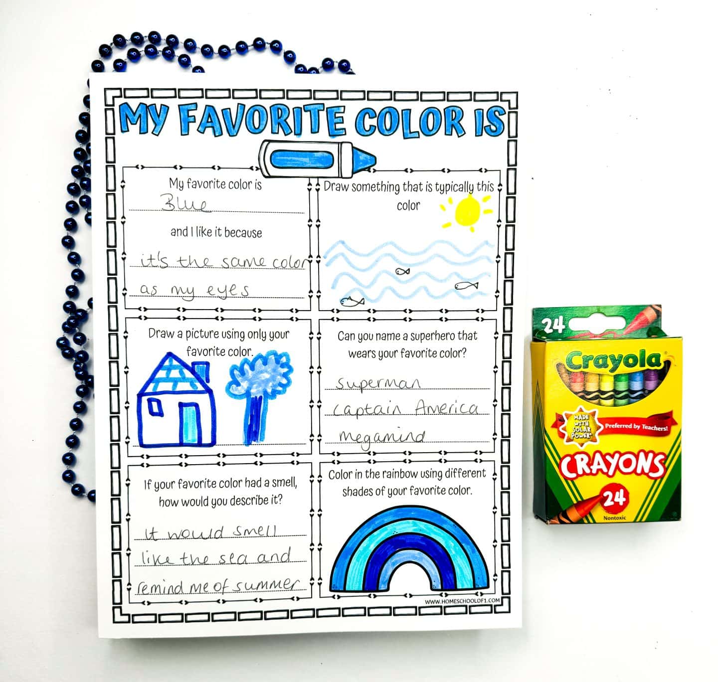 Printable worksheet for children titled 'My Favorite Color Is,' filled with blue crayon. It features a blue house drawing, superheroes associated with blue such as Superman and Captain America, and a blue-scented description reminiscent of the sea and summer.