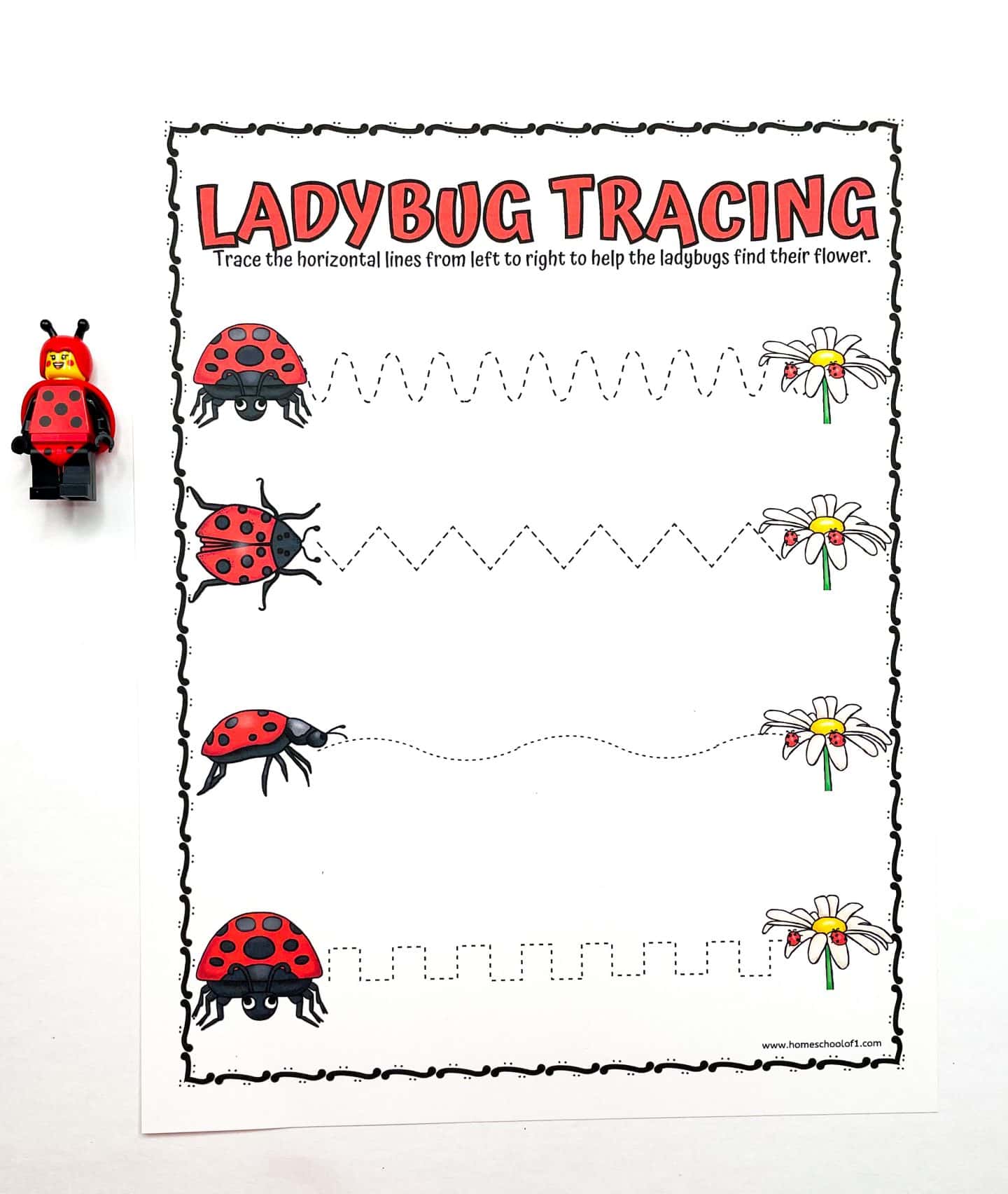 ladybug tracing worksheet, trace the horizontal lines from left to right, with a ladbyug lego minifigure next to the worksheet.
