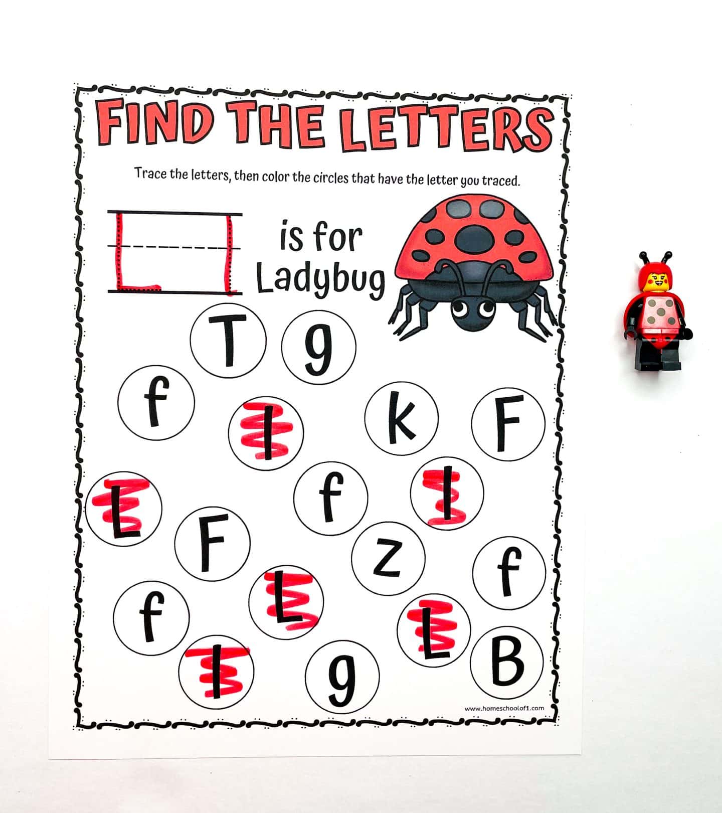 A preschool worksheet titled “Find the Letters” focuses on identifying the letter “L.” At the top, it shows how to trace an uppercase L, labeled “L is for Ladybug,” with an illustration of a red-and-black ladybug. Below are circles containing various letters; the uppercase Ls are highlighted in red. A LEGO ladybug figure is placed beside the worksheet on a white background.