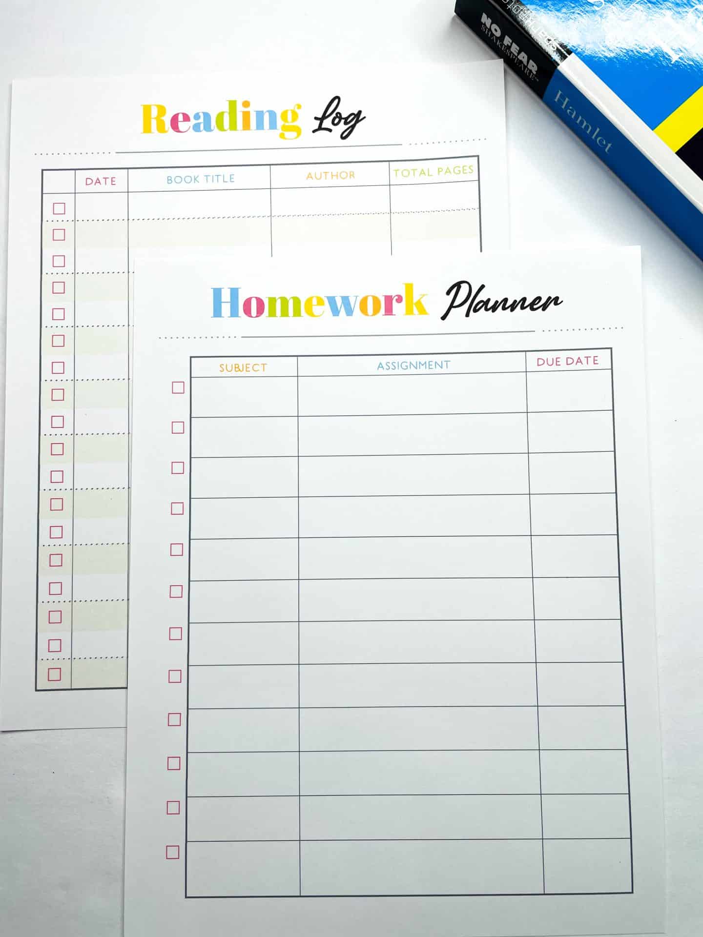 Two printable homeschool planning sheets are shown. The front page is a "Homework Planner" with columns for subject, assignment, and due date, along with checkboxes on the left. Behind it is a "Reading Log" with columns for date, book title, author, and total pages. A copy of Hamlet rests at the top right corner.


