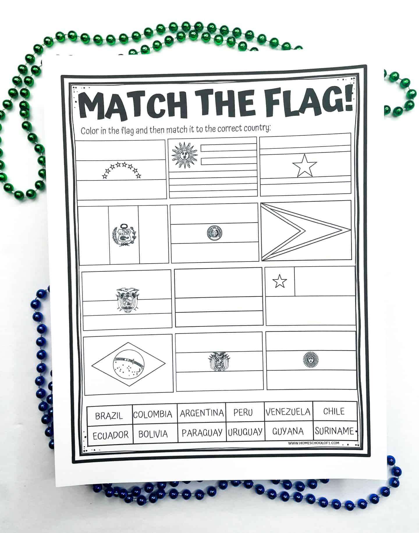 A black-and-white printable worksheet titled “Match the Flag!” displays twelve uncolored flags from South American countries. Below the flags is a list of country names including Brazil, Argentina, Colombia, Peru, Venezuela, Chile, Ecuador, Bolivia, Paraguay, Uruguay, Guyana, and Suriname. Students are instructed to color in the flags and match each one to the correct country. Green and blue bead necklaces frame the activity page decoratively.