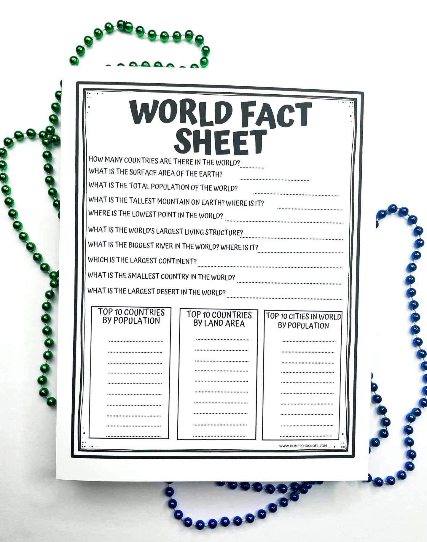 A black-and-white printable worksheet titled "World Fact Sheet" with a series of geography-related questions, such as population, area, tallest mountain, and largest desert. The bottom section has three columns labeled "Top 10 Countries by Population," "Top 10 Countries by Land Area," and "Top 10 Cities in World by Population" for students to fill in. Decorative green and blue beads surround the worksheet.
