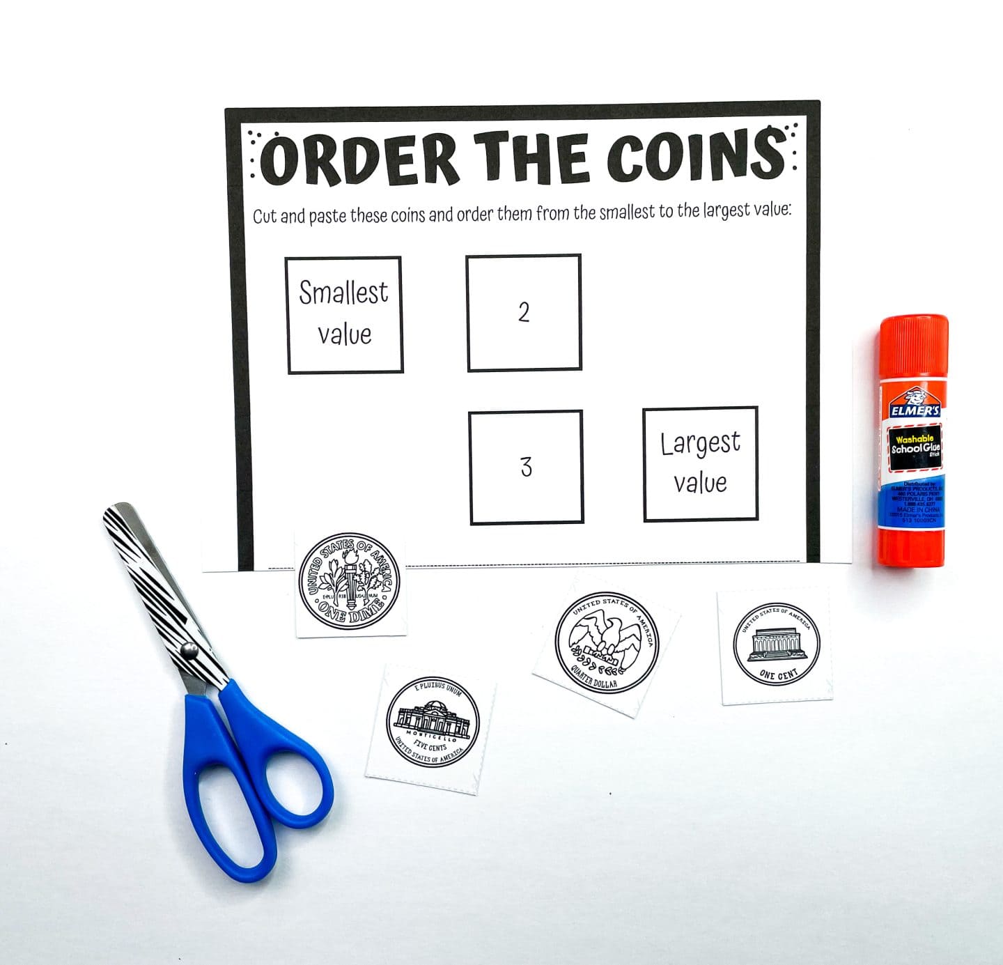 A printable coin worksheet titled "Order the Coins" instructs kids to cut and paste images of coins in order from smallest to largest value. Four cut-out black and white coin illustrations are placed around the worksheet. A pair of blue-handled scissors and an orange Elmer's glue stick sit beside the page, suggesting a hands-on coin value activity.