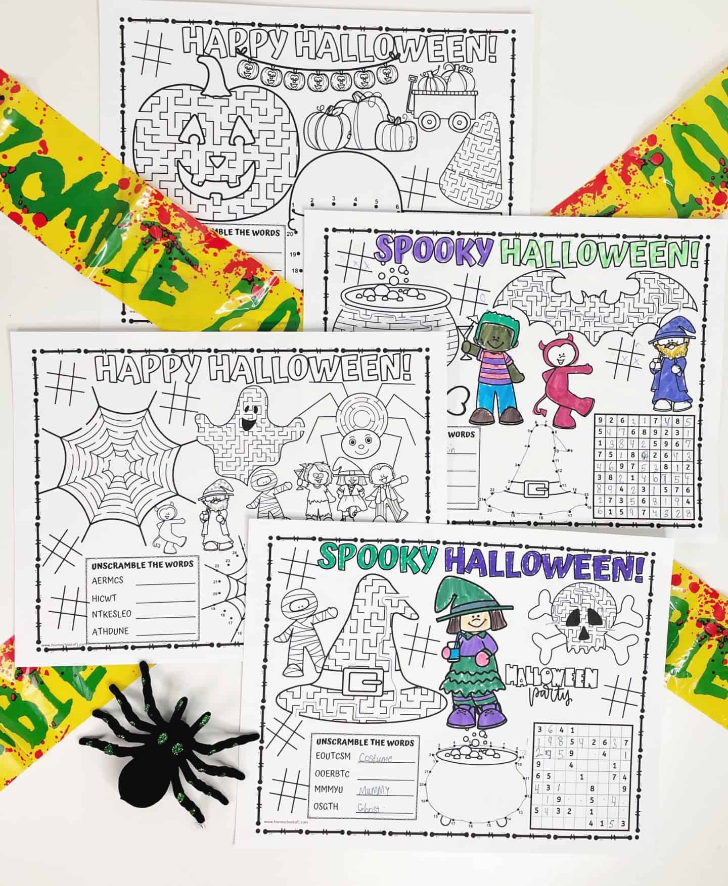 Four Halloween-themed printable placemats for kids, each featuring black-and-white activity sheets with mazes, word scrambles, coloring areas, and festive illustrations like pumpkins, witches, cauldrons, and candy. Some sections are partially colored in with bright markers. The placemats are surrounded by fake blood-splattered “Zombie” tape and a sparkly black spider decoration, perfect for spooky holiday fun.

