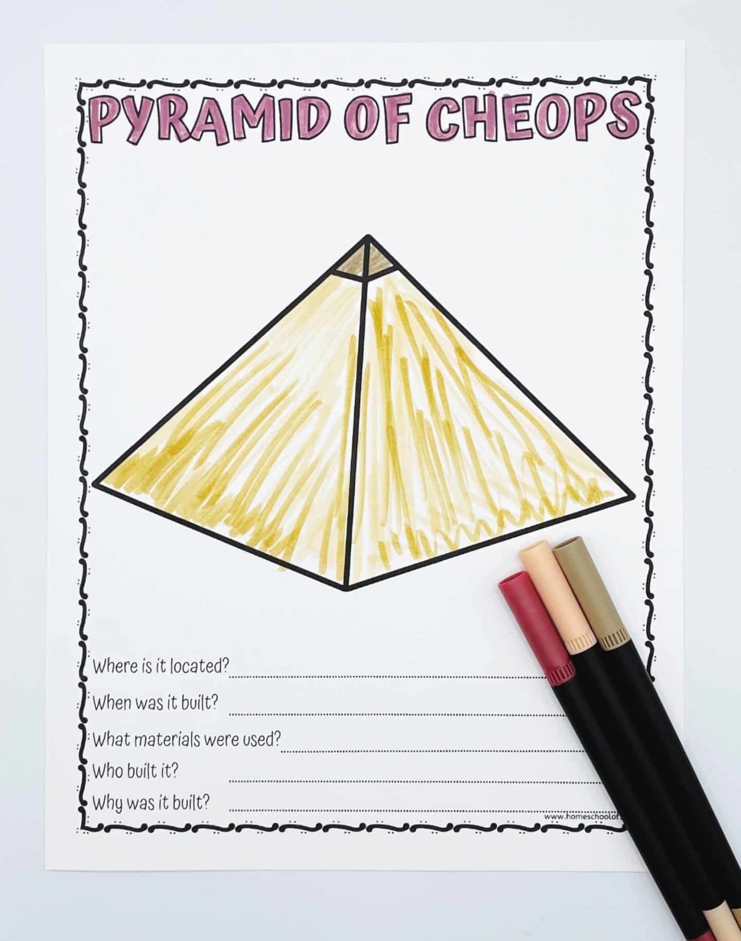 Pyramid of Cheops worksheet with a hand-colored pyramid and questions about its location, construction, materials, and purpose, shown with three markers.