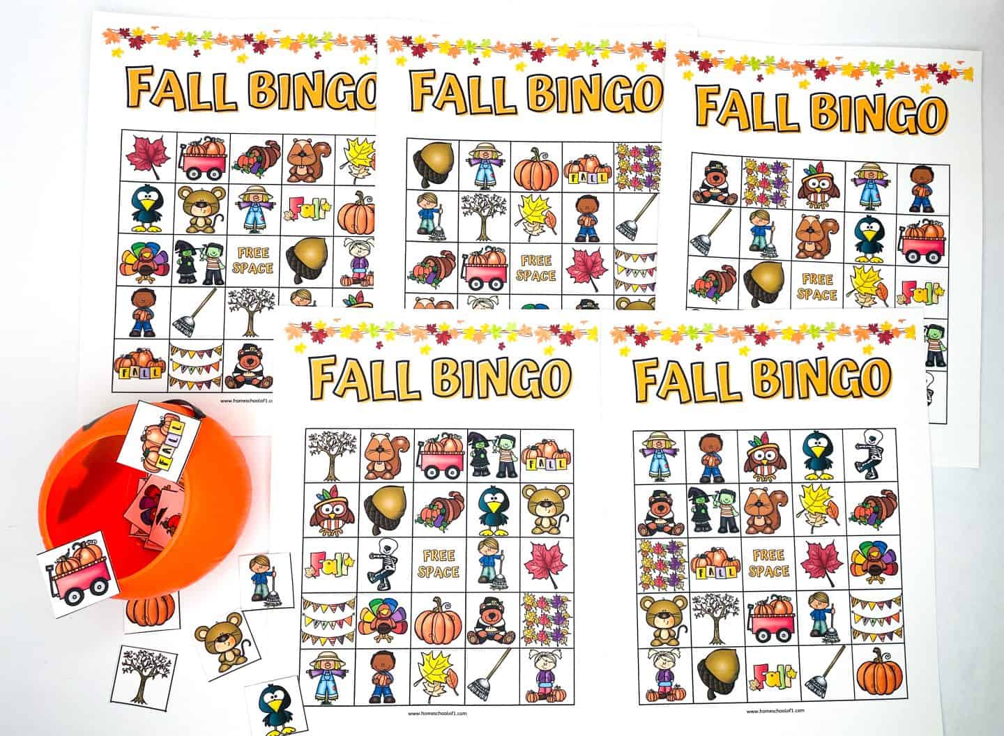A collection of Fall Bingo printable game cards featuring colorful autumn-themed illustrations like pumpkins, leaves, scarecrows, animals, and acorns. Each card has a unique layout with a "Free Space" in the center. An orange plastic pumpkin holds the calling cards, perfect for drawing during play. This Fall Bingo printable set is ideal for classroom parties, family gatherings, or fall festivals.