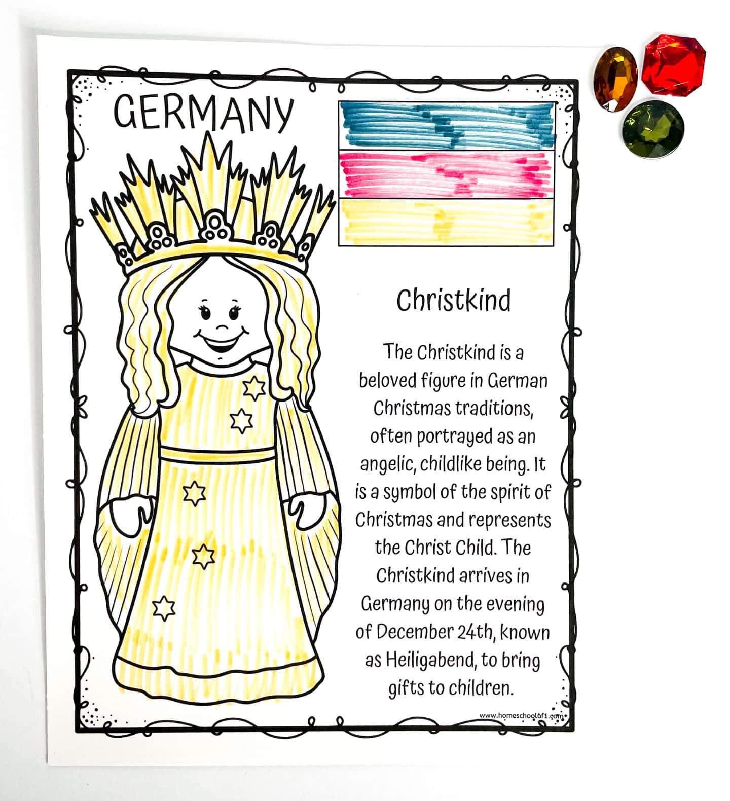 Coloring worksheet about the Christkind, a German Christmas tradition, featuring a smiling, angelic figure in a long yellow gown and golden crown. The page includes a short paragraph explaining that the Christkind represents the Christ Child and brings gifts to children in Germany on Christmas Eve. A small hand-colored German flag and three plastic gem decorations are in the upper right corner.