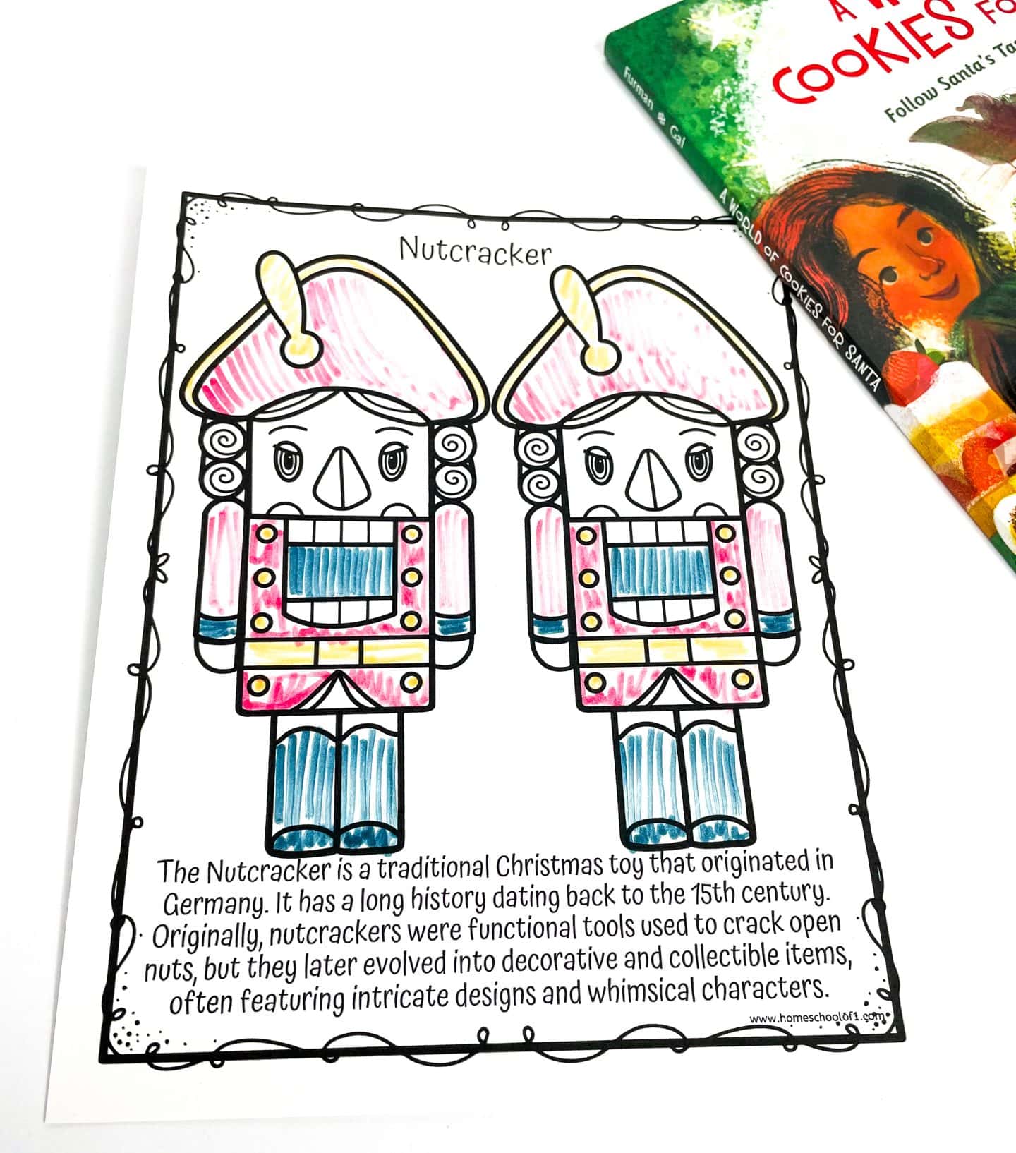 Coloring page featuring two traditional German nutcrackers side by side, partially colored with pink, blue, and yellow. The accompanying text explains that nutcrackers originated in Germany in the 15th century as tools for cracking nuts and later became decorative collectibles known for their whimsical designs. A corner of the book A World of Cookies for Santa is visible in the upper right.