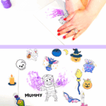 Finished Halloween mummy handprint craft decorated with colorful stickers and purple handprints.