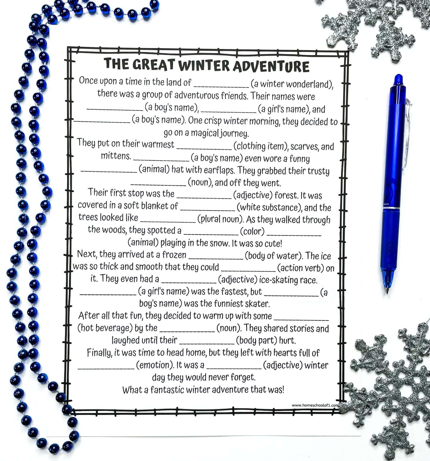 A blank printable worksheet titled “The Great Winter Adventure” sits on a white surface, ready for kids to fill in with creative word choices. It includes fill-in-the-blank spaces for nouns, adjectives, and other parts of speech to create a personalized winter-themed Mad Libs story. The page is decorated with a border and surrounded by glittery silver snowflakes, a blue pen, and a string of dark blue beads. The worksheet is from homeschoolof1.com.
