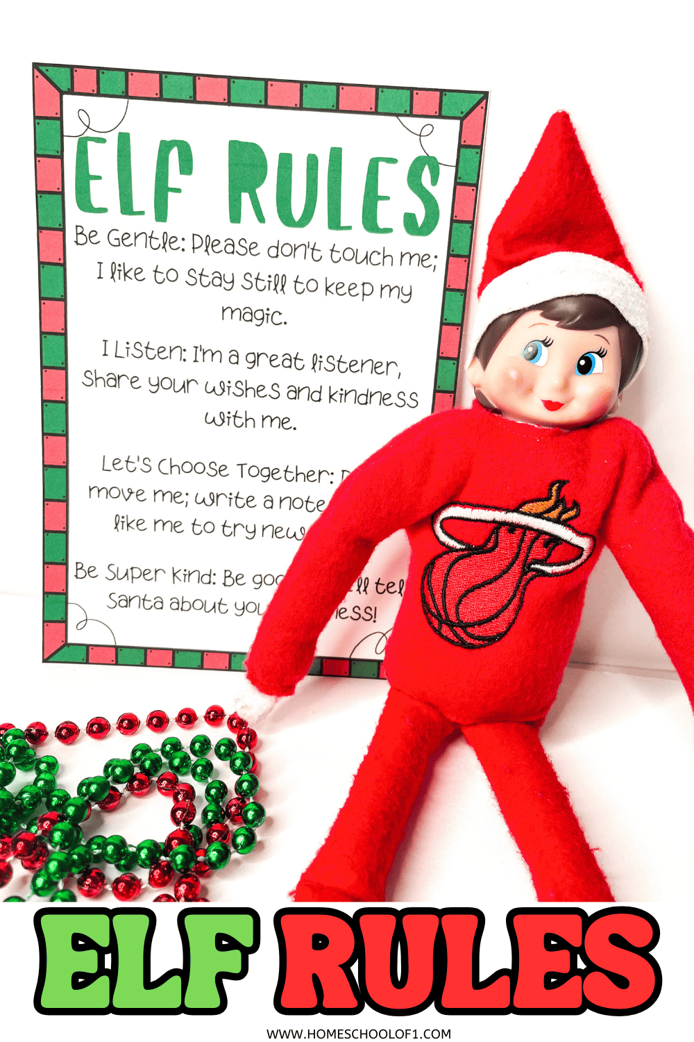 Elf on the Shelf sitting next to a printed set of elf rules with festive red and green beads.