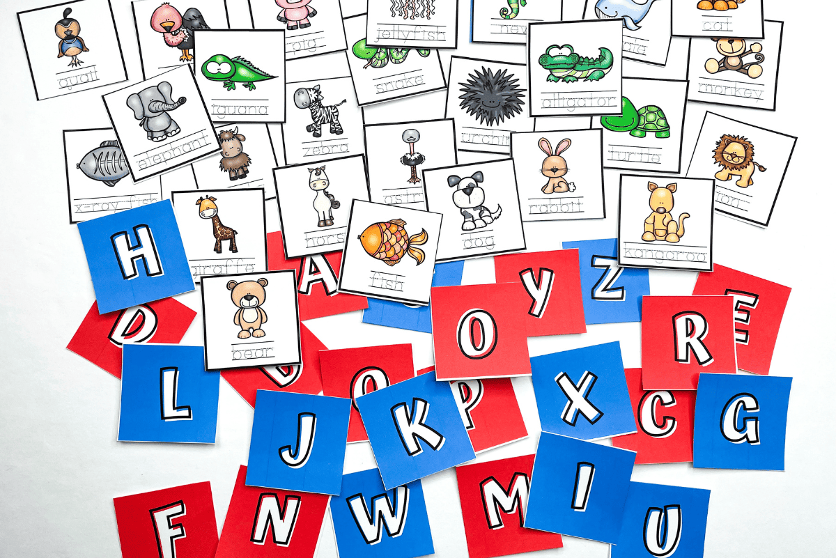 Thumbnail of an alphabet memory game printable featuring colorful red and blue cards with uppercase letters and matching picture cards with illustrated animals and objects like fish, lion, mouse, and umbrella. Designed to help kids learn letter recognition and sounds through fun matching.