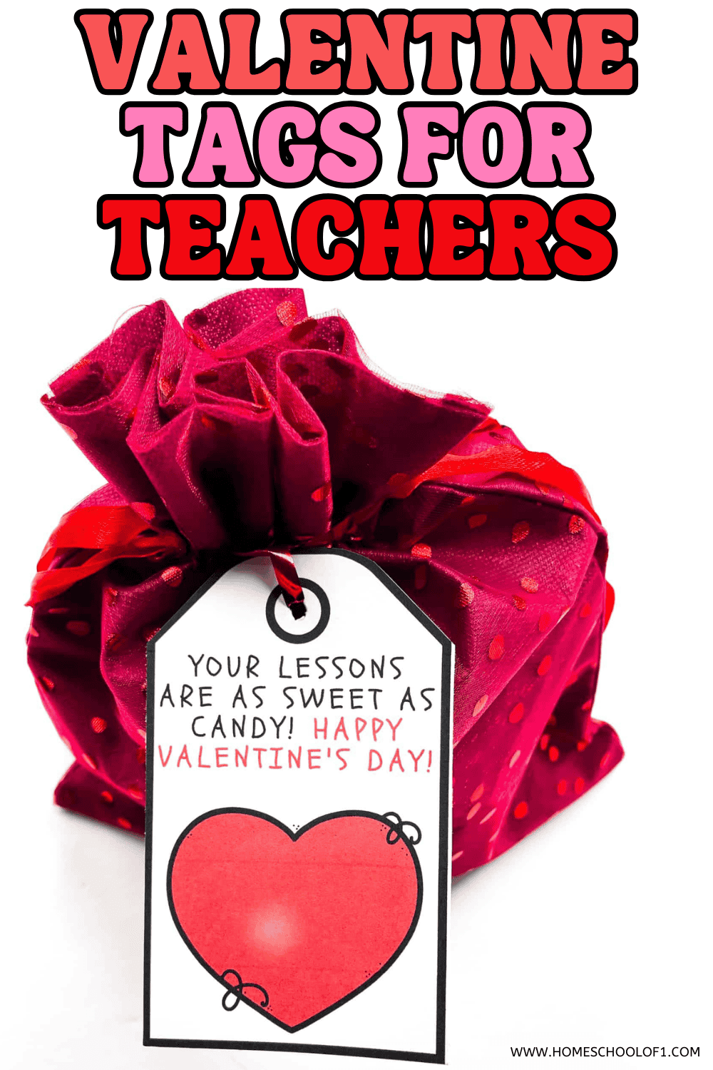 Teacher Valentine tag with heart design tied onto a pink fabric-wrapped gift.