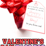 Valentine tag for teachers attached to a red gift with a large bow.