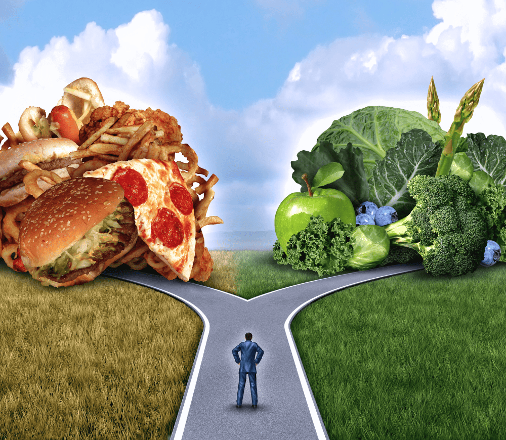 healthy food choices and a man at a crossroads, does he choose green healthy food, or pizza, hamburgers and fries?