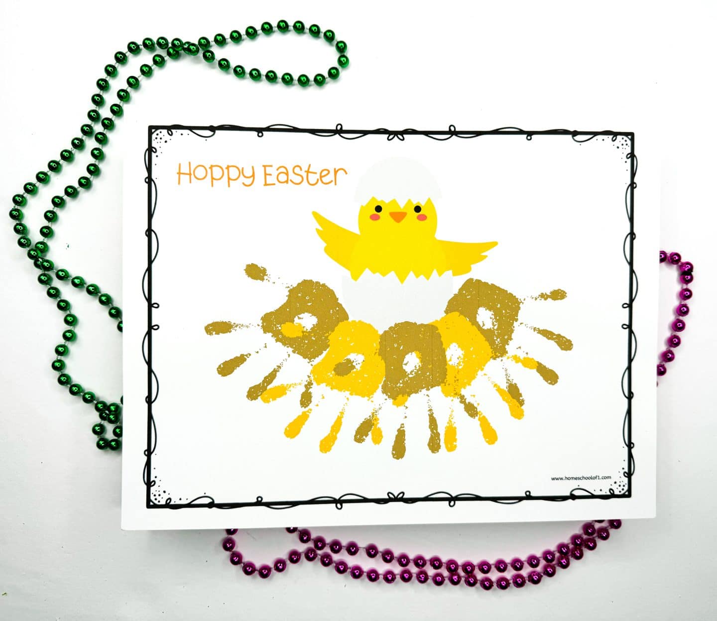 Easter handprint art project showing a cheerful yellow chick hatching from a white eggshell, with the phrase “Hoppy Easter” in orange at the top left. Kids' painted handprints in shades of yellow and brown form a semi-circle nest beneath the chick. Green and pink bead necklaces frame the artwork, adding a festive touch.