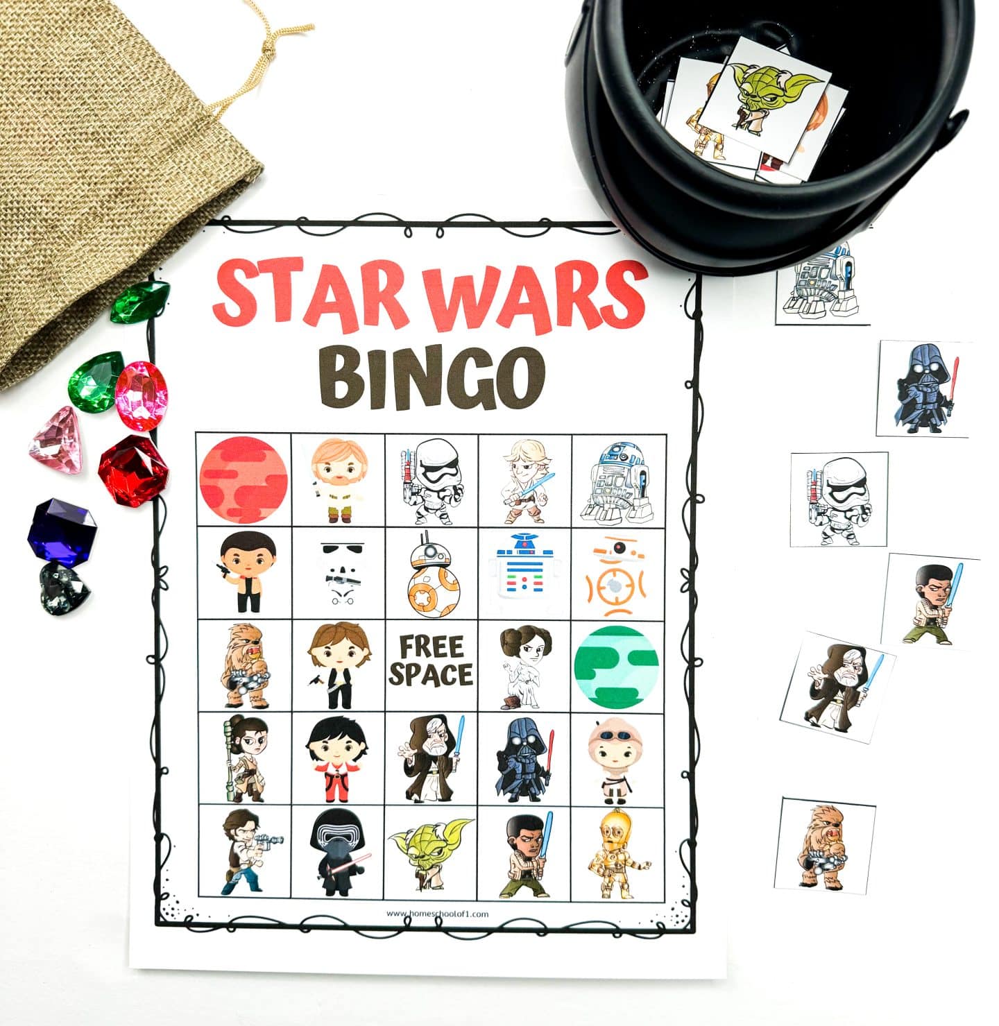 A colorful Star Wars-themed bingo game in play, featuring cartoon-style characters like Darth Vader, Rey, and BB-8. The bingo card is partially filled with colorful plastic gems, and small character tiles are scattered around.

