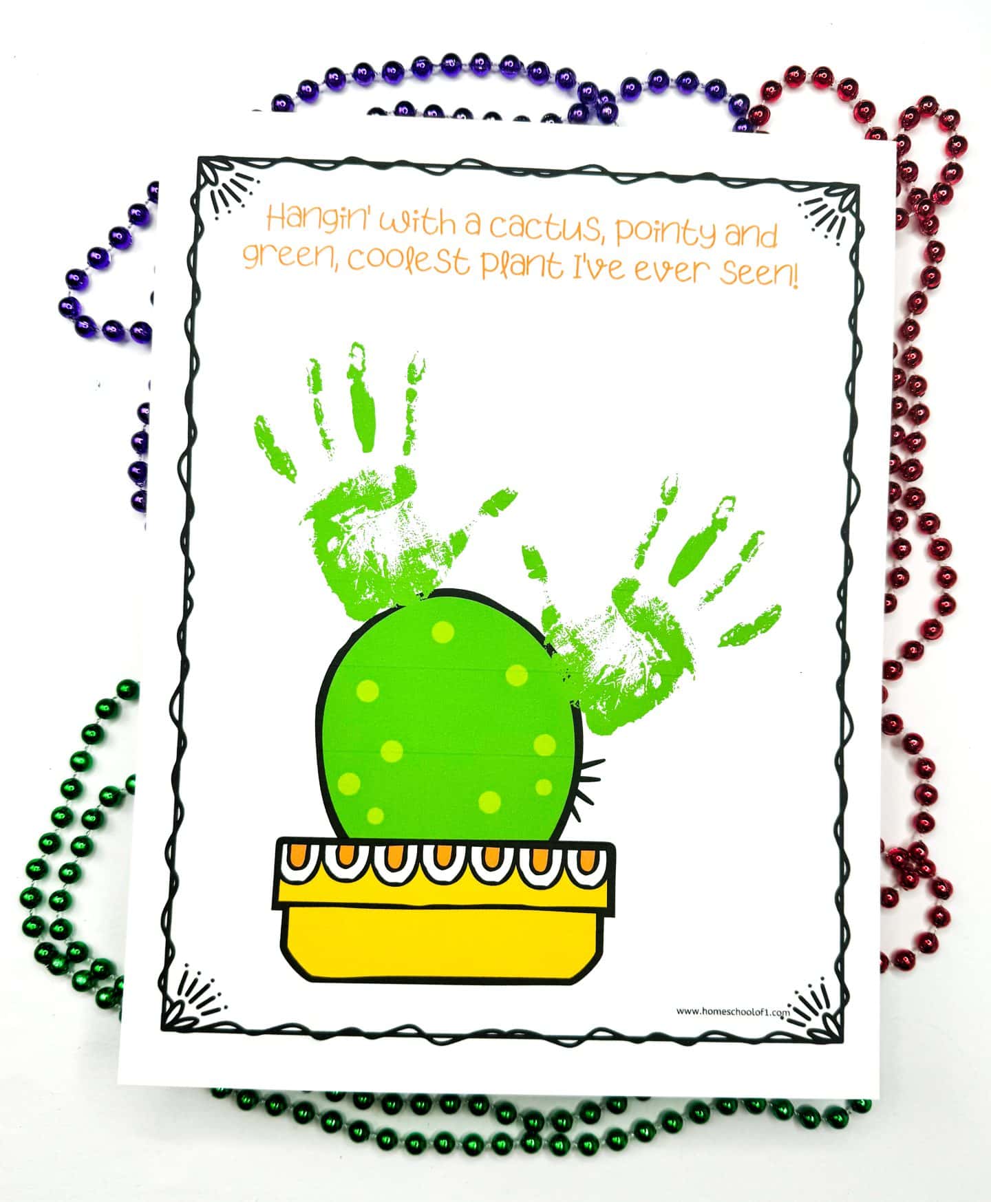 A creative handprint art piece illustrating a cactus, featuring the text "Looking sharp!" adding a playful touch to the design.