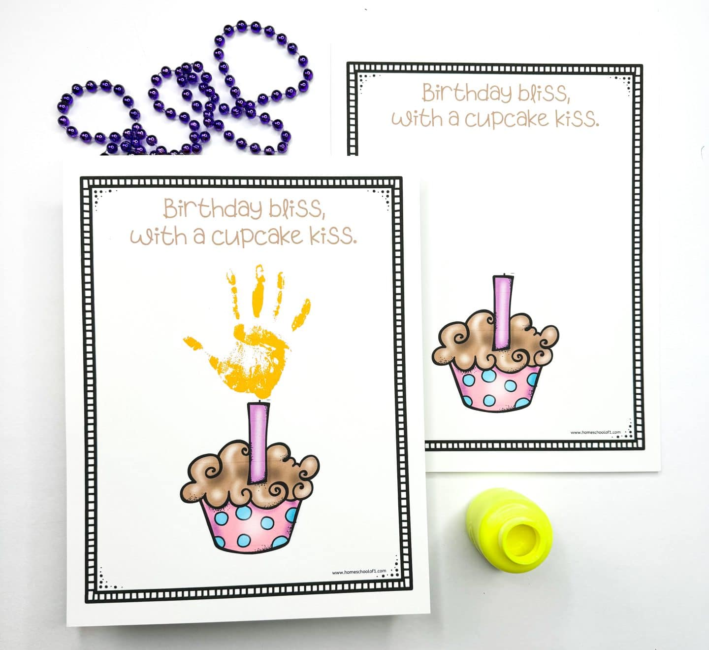 Printable birthday handprint art featuring a whimsical cupcake with a purple candle and the phrase “Birthday bliss, with a cupcake kiss.” One sheet shows a yellow painted handprint as the candle flame, while the other is blank for kids to add their own handprint. Includes purple beads and a yellow paint bottle as decoration ideas.
