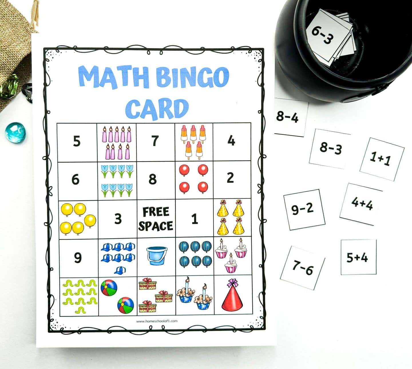 Printable math bingo card for kids featuring a 5x5 grid filled with numbers and colorful party-themed images like balloons, candles, presents, and cupcakes, with a "Free Space" in the center. Around the card are small squares with simple math problems like “1+1,” “9-2,” and “4+4,” alongside a black cauldron holding additional flashcards.