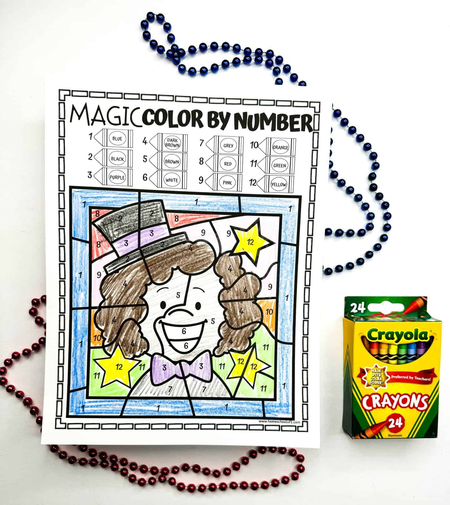 A color by number art piece showing a cheery magician with a purple hat and green bow tie, accompanied by a Crayola crayon box and red and blue beads.
