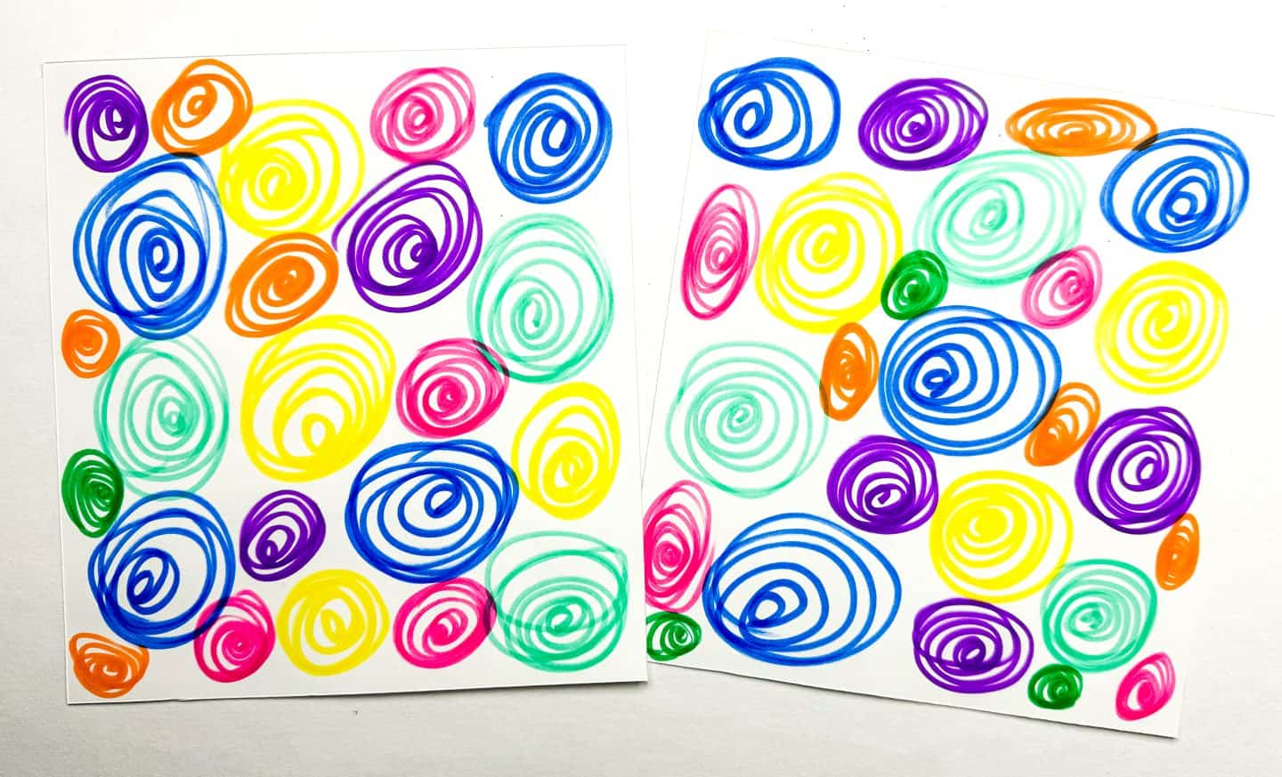 Blank sides of 'Shakespeare Memory Game' cards visible, with hand-drawn colorful swirls in various hues, arranged for a memory matching game.