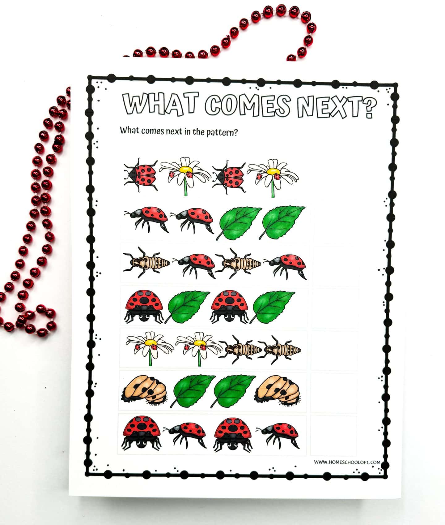 Printable 'What Comes Next?' pattern recognition worksheet, displaying colored sequences of ladybugs, leaves, flowers, and larvae for children to determine the next in sequence, embellished with red beads