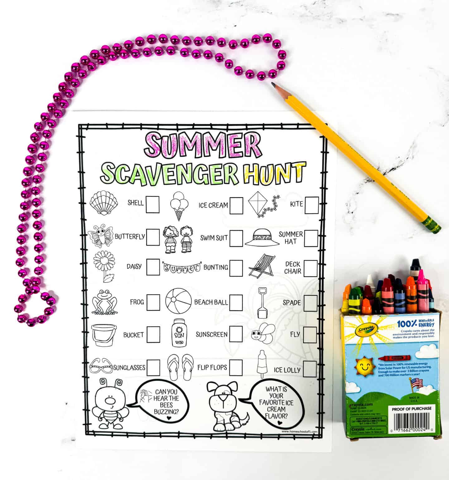 A black-and-white summer scavenger hunt checklist sheet placed on a white marble surface, surrounded by a yellow pencil, pink metallic beads, and a box of Crayola crayons. The sheet lists summer-themed items like shell, ice cream, beach ball, and kite with checkboxes next to playful line art.