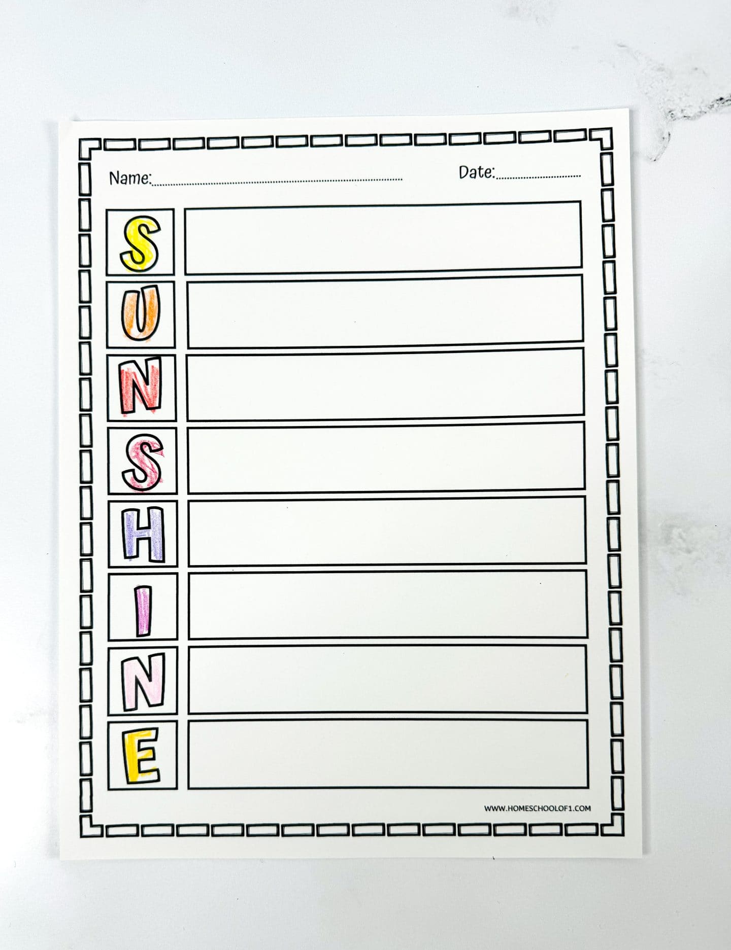  A vertical acrostic poem worksheet for the word “SUNSHINE,” with each letter in a colored box down the left side. The rest of the page has blank horizontal lines for writing. There are fields at the top for name and date, and a decorative square border frames the worksheet.