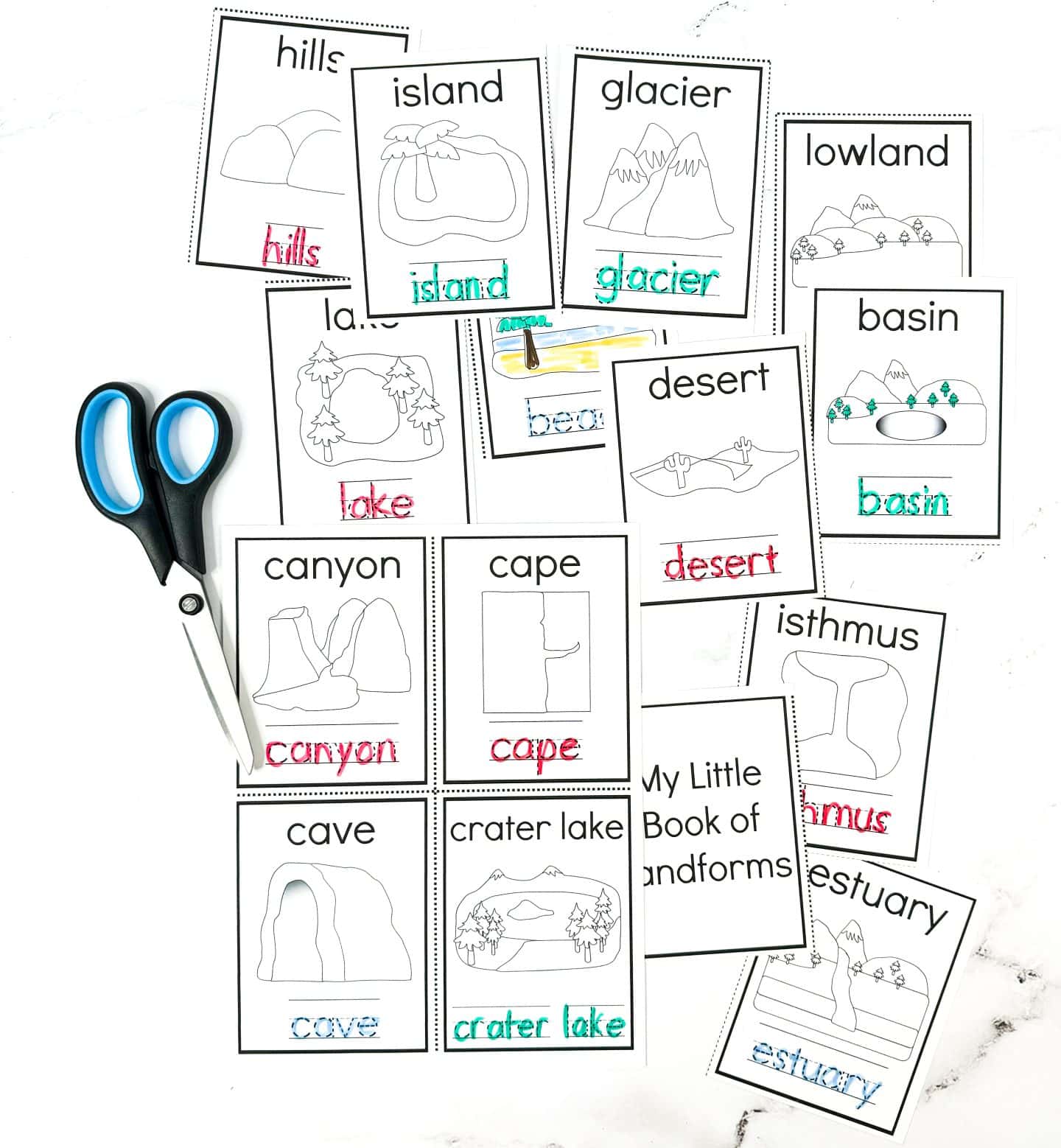 This image features a spread of printable landform flashcards titled “My Little Book of Landforms,” laid out with a pair of scissors for a cut-and-learn activity. Each card includes a labeled illustration, with the landform name also written in dotted tracing font and filled in with markers. Visible landforms include: hills, island, glacier, lowland, lake, beach, desert, basin, canyon, cape, cave, crater lake, isthmus, and estuary—making it a vibrant and interactive geography learning tool for kids.







