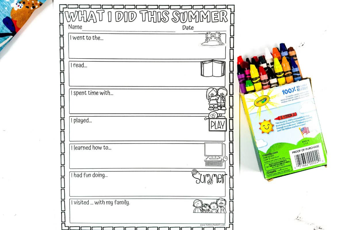 A black and white “What I Did This Summer” worksheet for kids, placed next to a box of Crayola crayons on a white surface. The worksheet includes fill-in-the-blank prompts such as “I went to the…”, “I read…”, and “I had fun doing…”, each with a matching line-art illustration beside it.