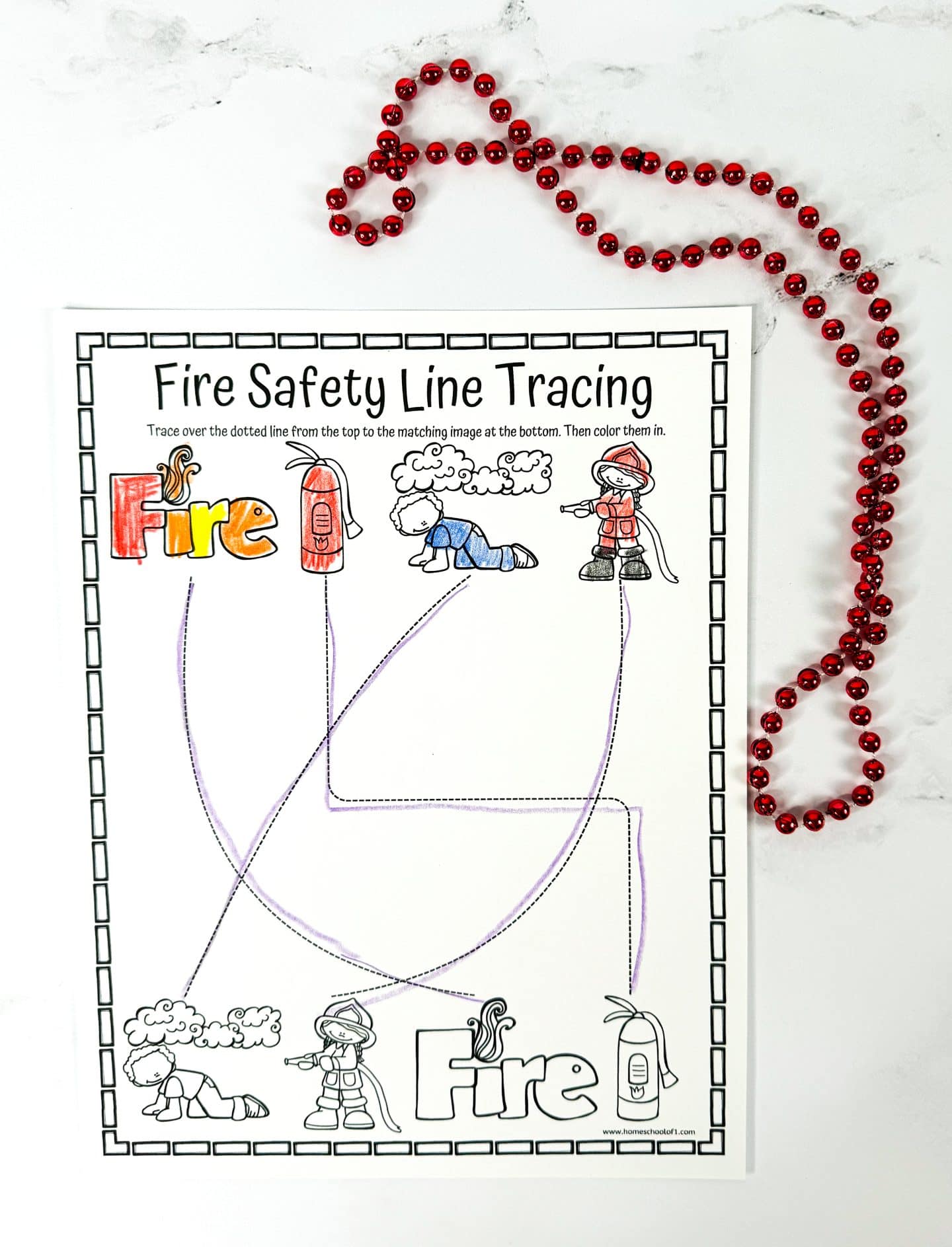 Fire safety line tracing worksheet where kids trace lines from images at the top—fire, extinguisher, crawling child, firefighter—to matching illustrations at the bottom. Includes fun drawings to color and reinforces fire safety concepts like staying low and using fire extinguishers.