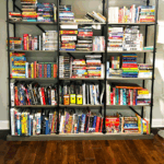 Large bookshelf filled with children's and middle grade books, with text overlay reading “21 Best Books for 11 Year Old Boys” from Homeschool of 1