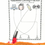 Close-up of Halloween cutting practice worksheet with colored-in bat, pumpkin, candy, and spider images and red kids' scissors.