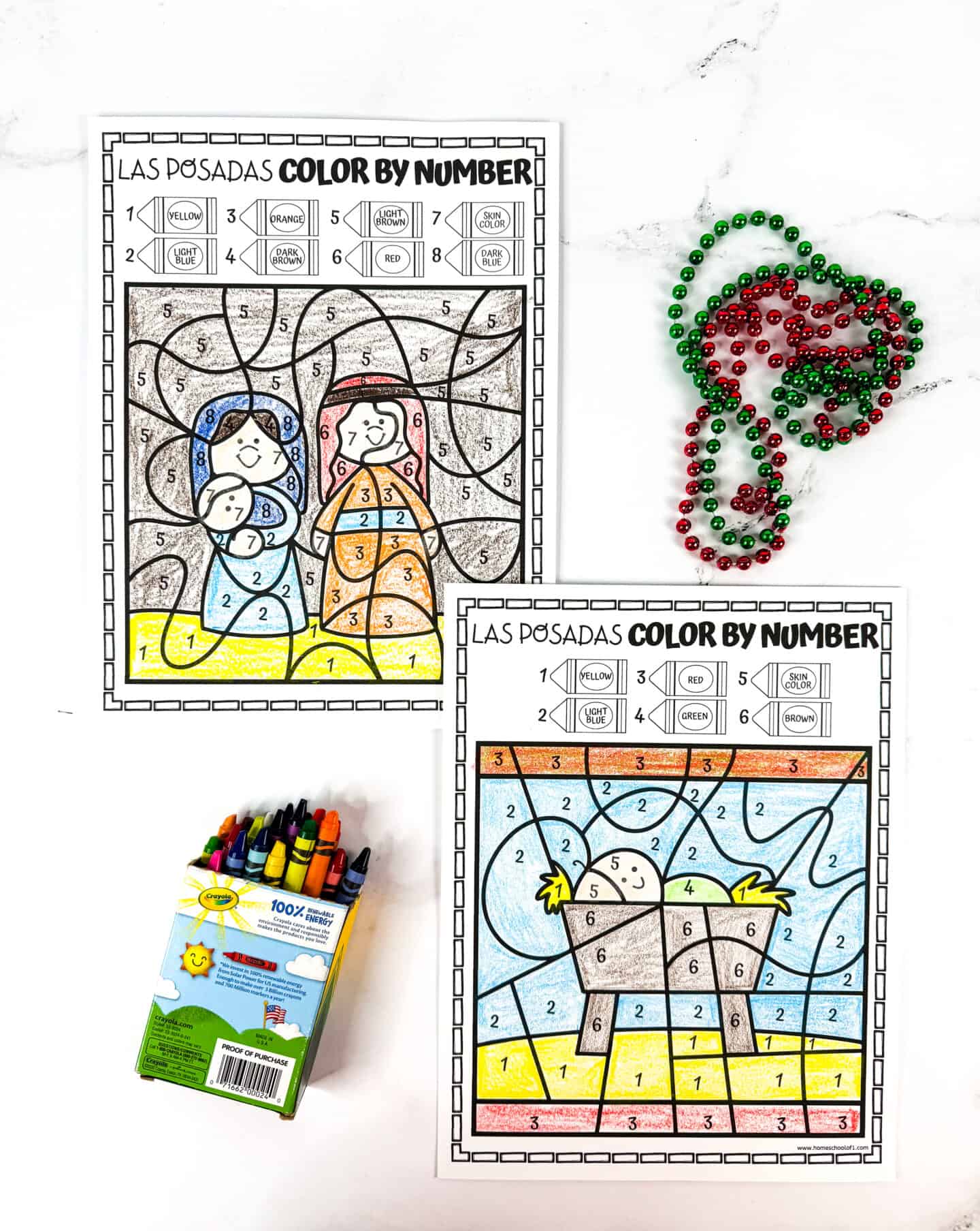 FREE MARY AND JOSEPH COLOR BY NUMBER worksheets colored in crayola crayons with red and green beads scattered on the table